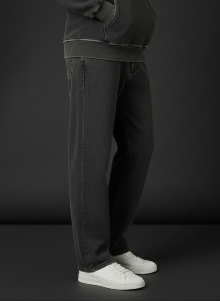 Person wearing dark gray pants and white sneakers on a black background