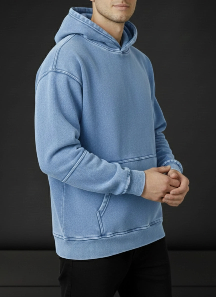 Person wearing a blue hoodie against a black background