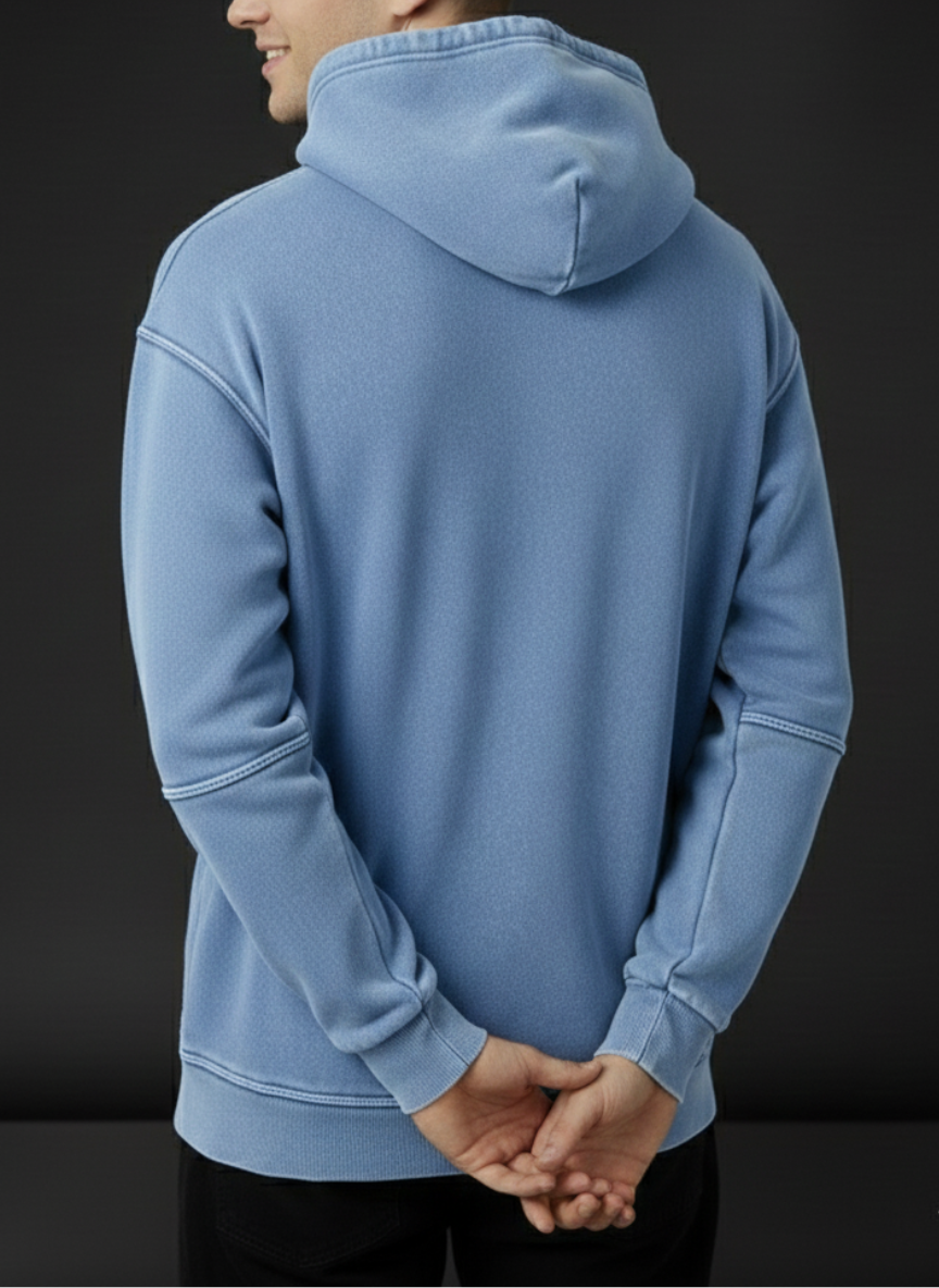 Person wearing a blue hoodie with a black background