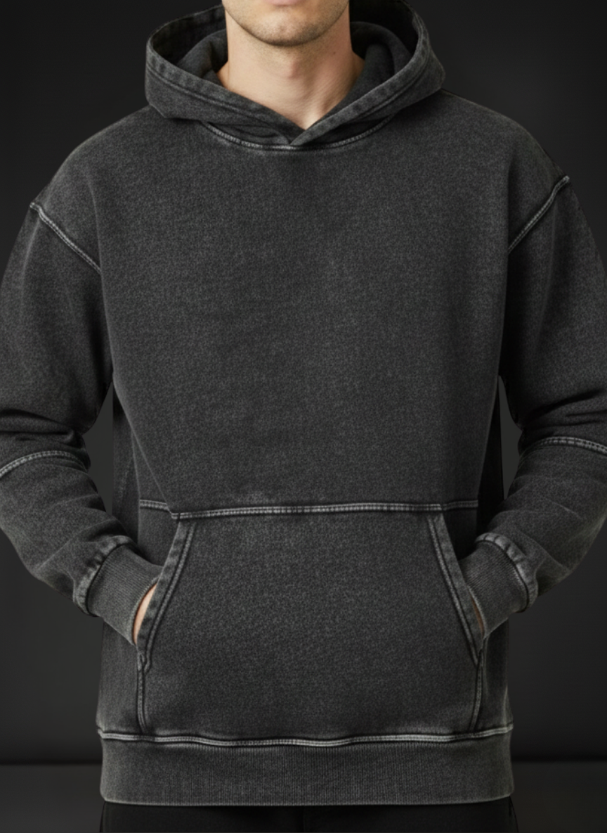 Person wearing a dark gray hoodie against a black background