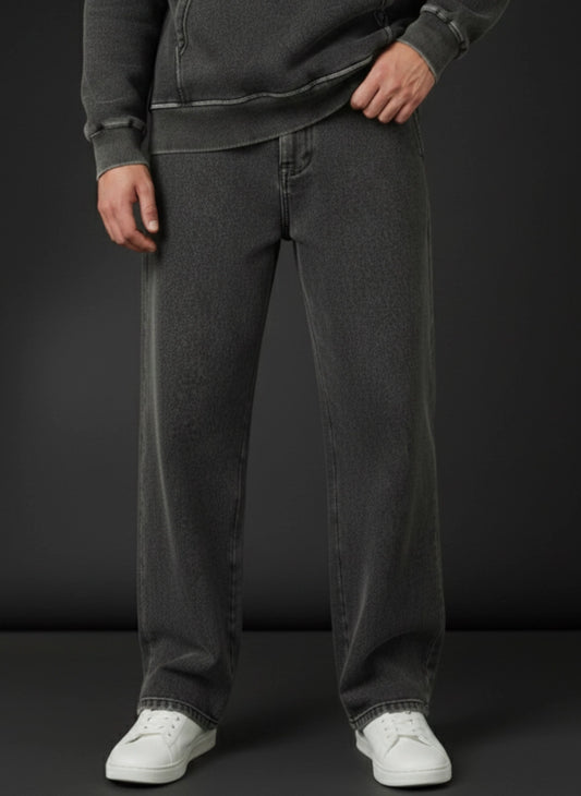 Person wearing dark gray trouser and white sneakers on a black background