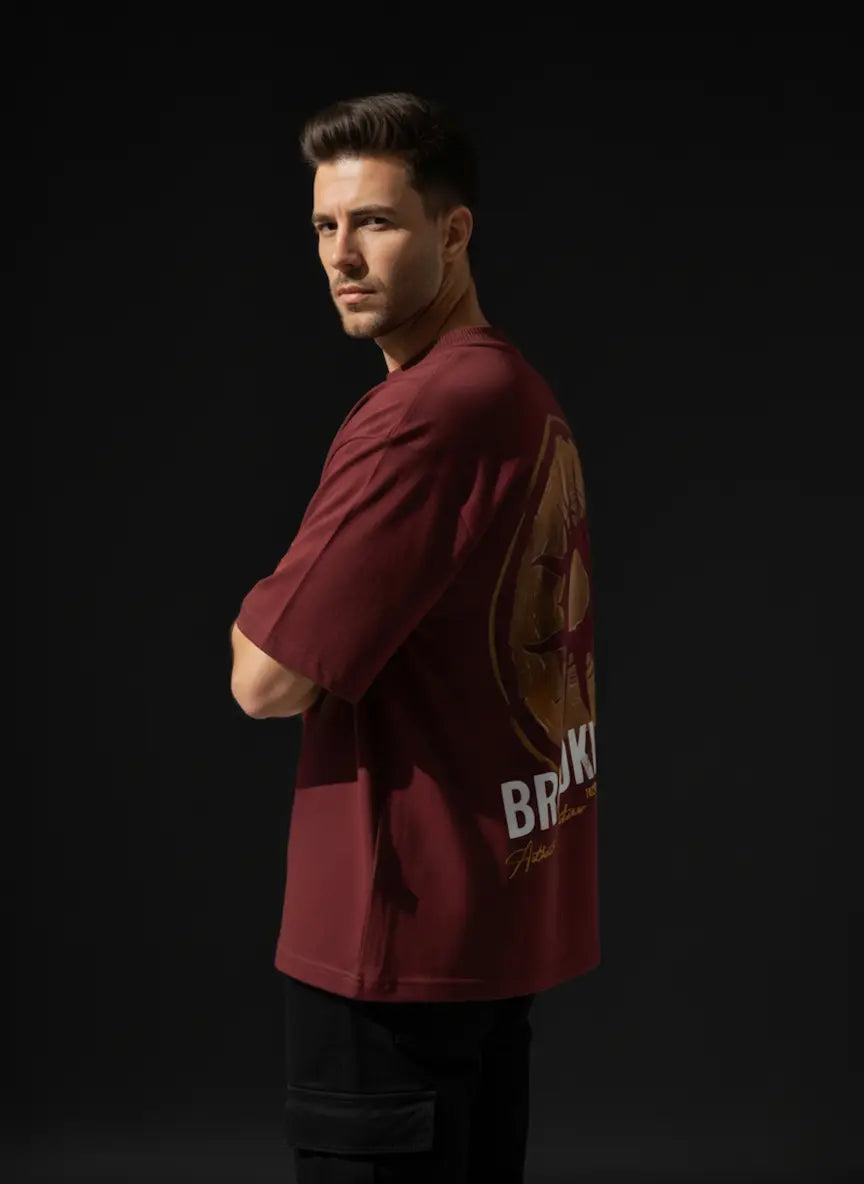 Man wearing a maroon sports jersey with visible branding on a black background