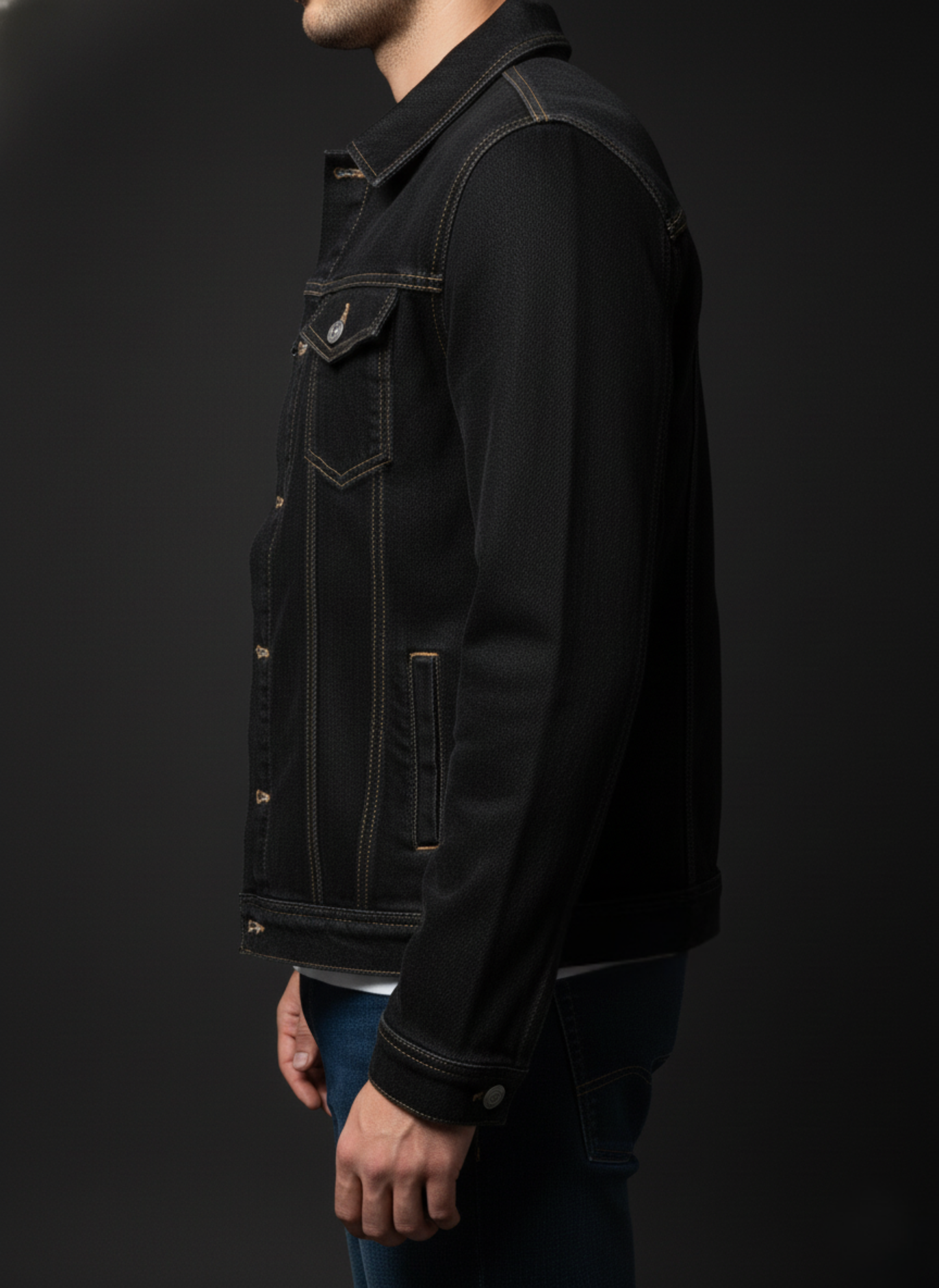 Black denim jacket worn by a person on a black background