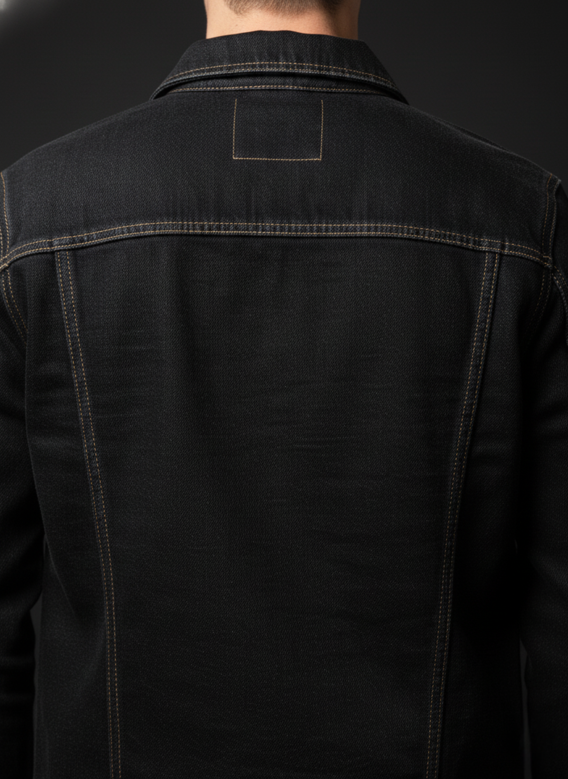 Black denim jacket on a black background