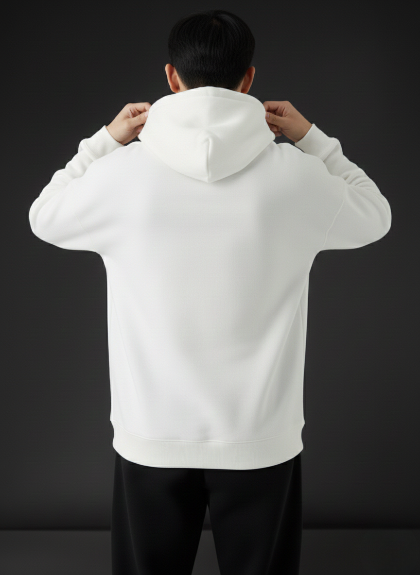 Person wearing a white hoodie against a black background