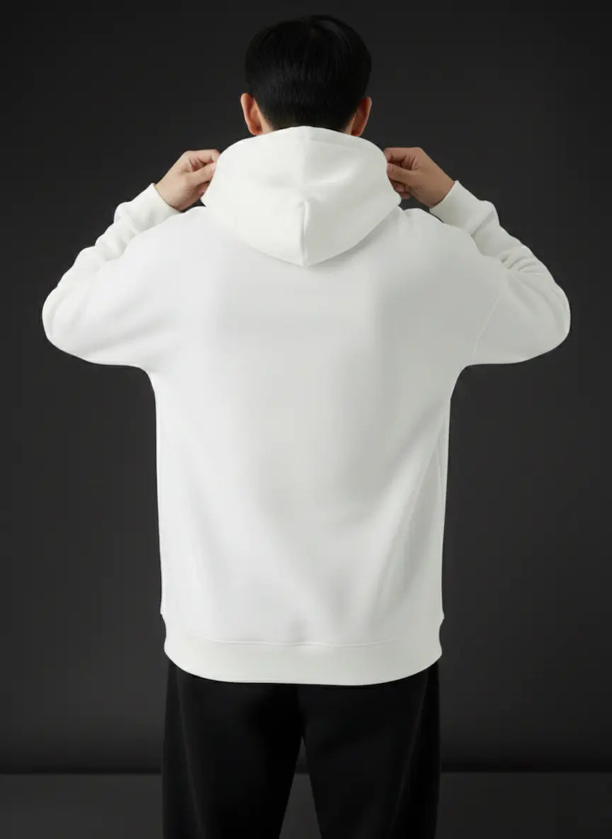 Person wearing a white hoodie with the back to the camera on a black background