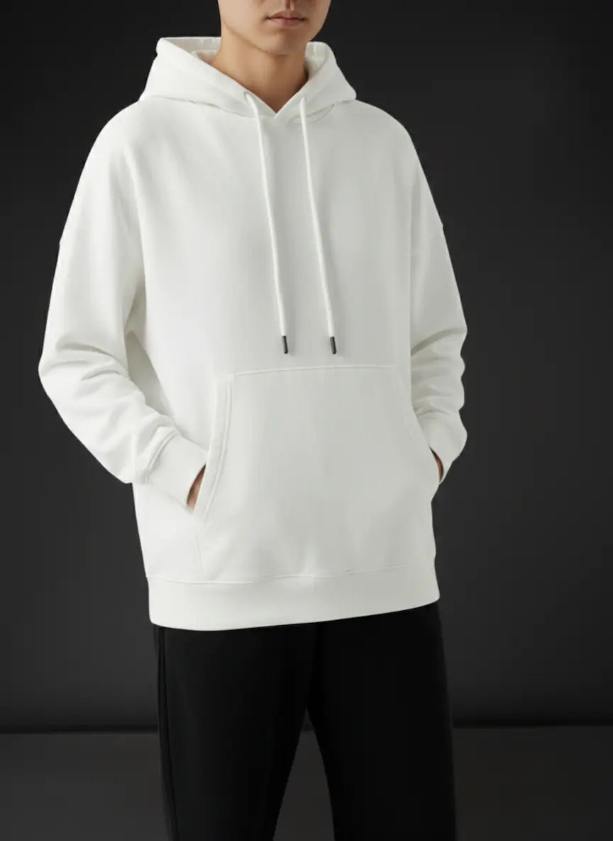 Person wearing a white hoodie against a black background