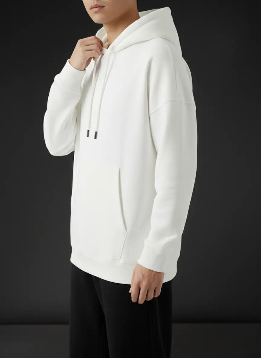 Person wearing a white hoodie against a black background