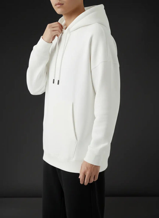Person wearing a white hoodie against a black background