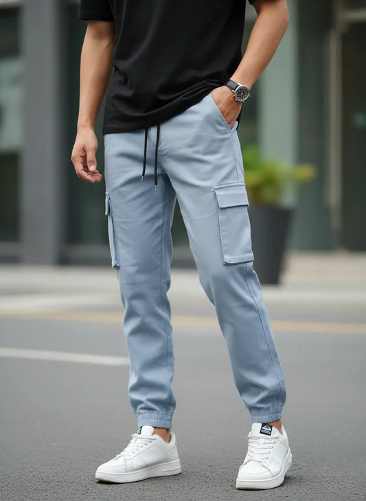 Person wearing Frost Edge Cargo Trouser and white sneakers on a blurred street background