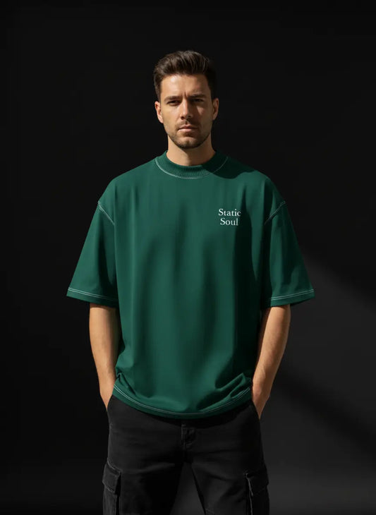Man wearing a Green Oversized Cotton T-Shirt with 'Static Soul' text on a black background