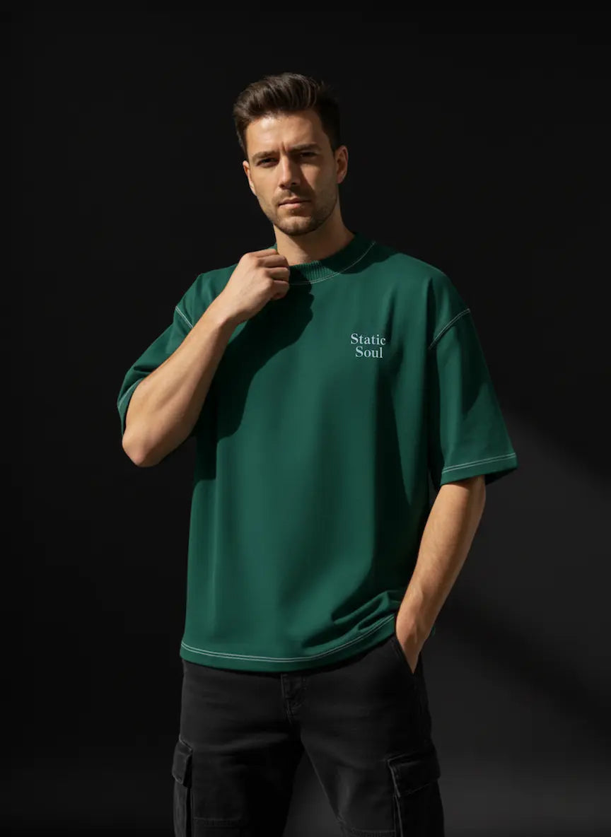 Man wearing a green t-shirt with 'Static Soul' logo against a black background