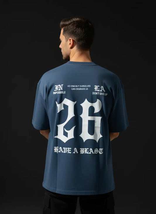 Person wearing a HAVE A BLAST Oversized Cotton T-Shirt with white text and numbers on the back against a black background