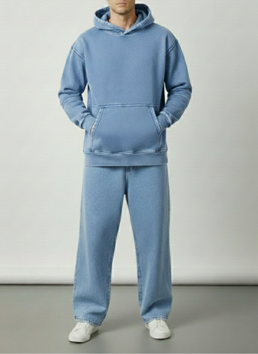 Person wearing a blue tracksuit against a plain background