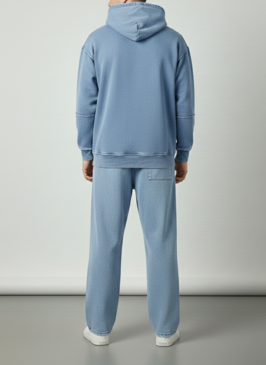 Person wearing a blue tracksuit against a plain background