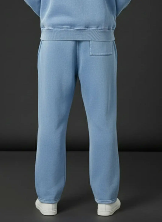 Light blue tracksuit with white shoes on a dark background