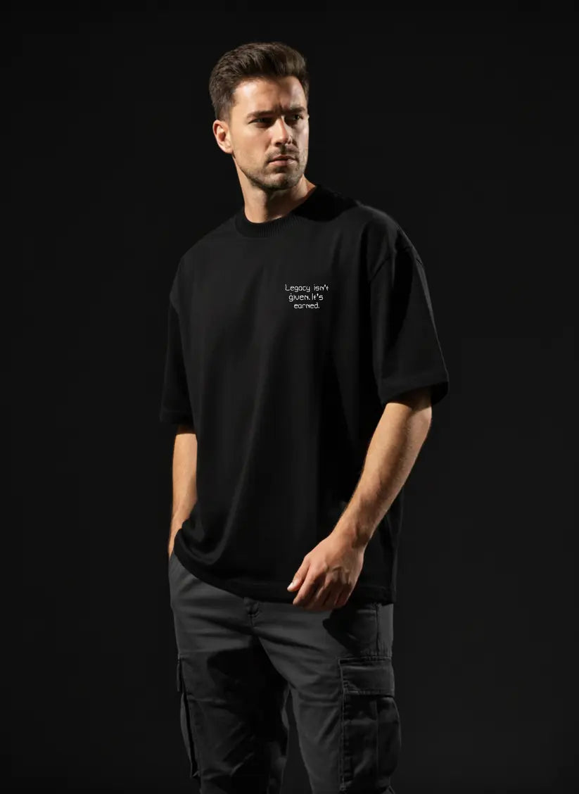 Man wearing a MARCO Oversized Cotton T-Shirt with text on a black background